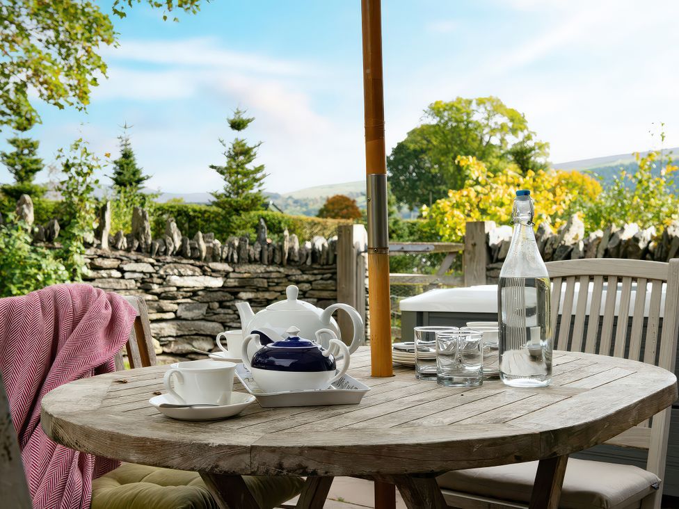 A table with tea set and water bottle at Shepherds Cottage in Llandrillo
