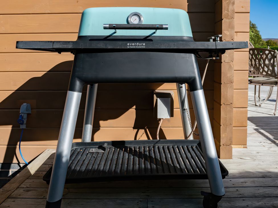 A grill located on a deck at Lagom Log Cabin in Llandrillo