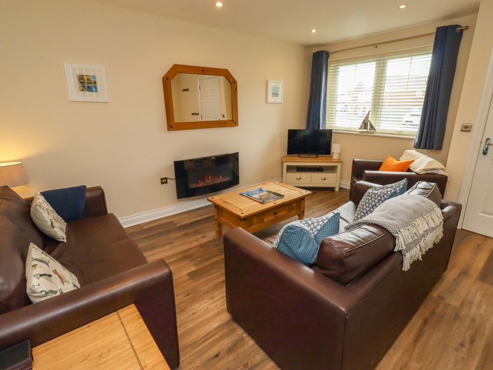 A living room with sofas and a television at 35 Longbeach Drive