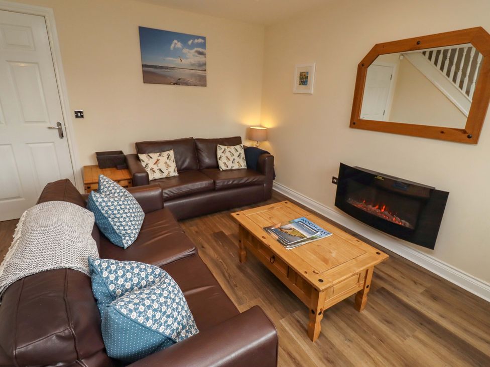 A living room with a sofa and coffee table at 35 Longbeach Drive