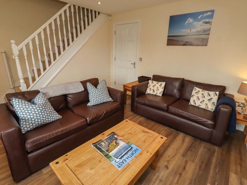 A living room with sofas and a coffee table at 35 Longbeach Drive