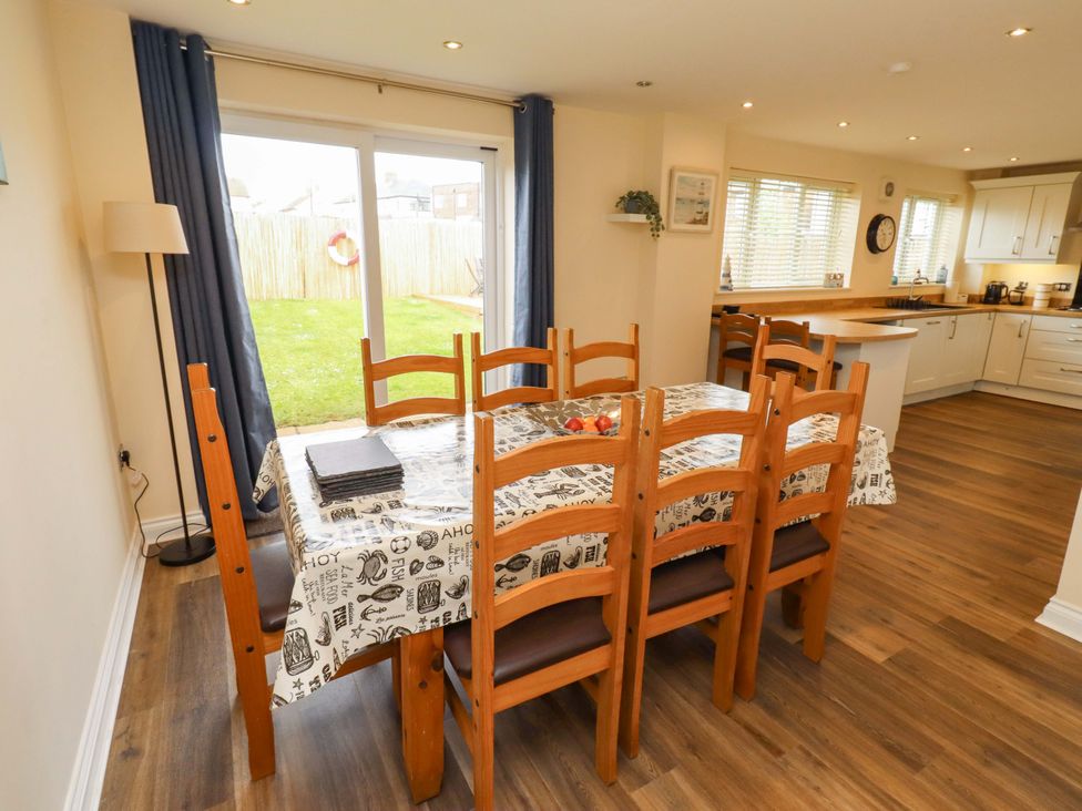 A dining room with a table and chairs at 35 Longbeach Drive