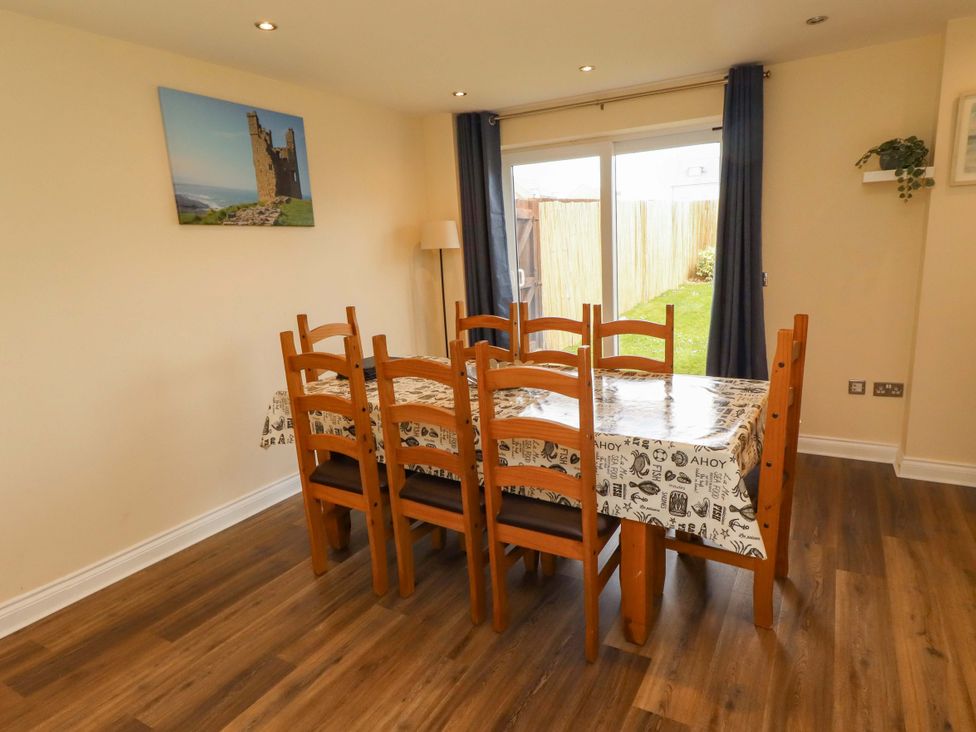 A dining room with a table and chairs at 35 Longbeach Drive