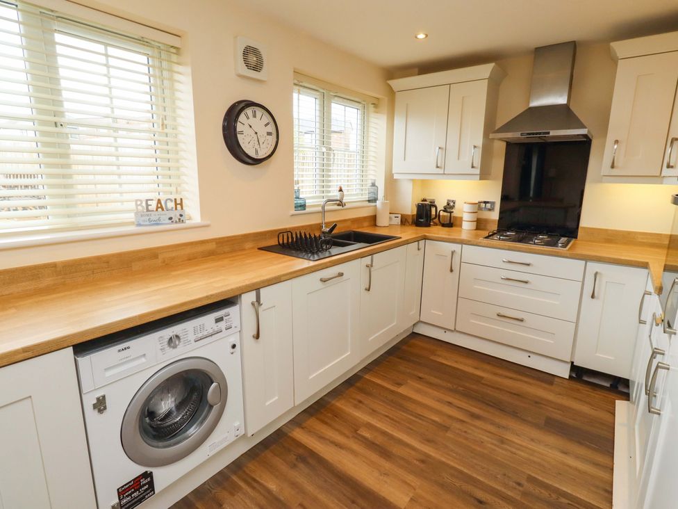 A kitchen with sink and washing machine at 35 Longbeach Drive