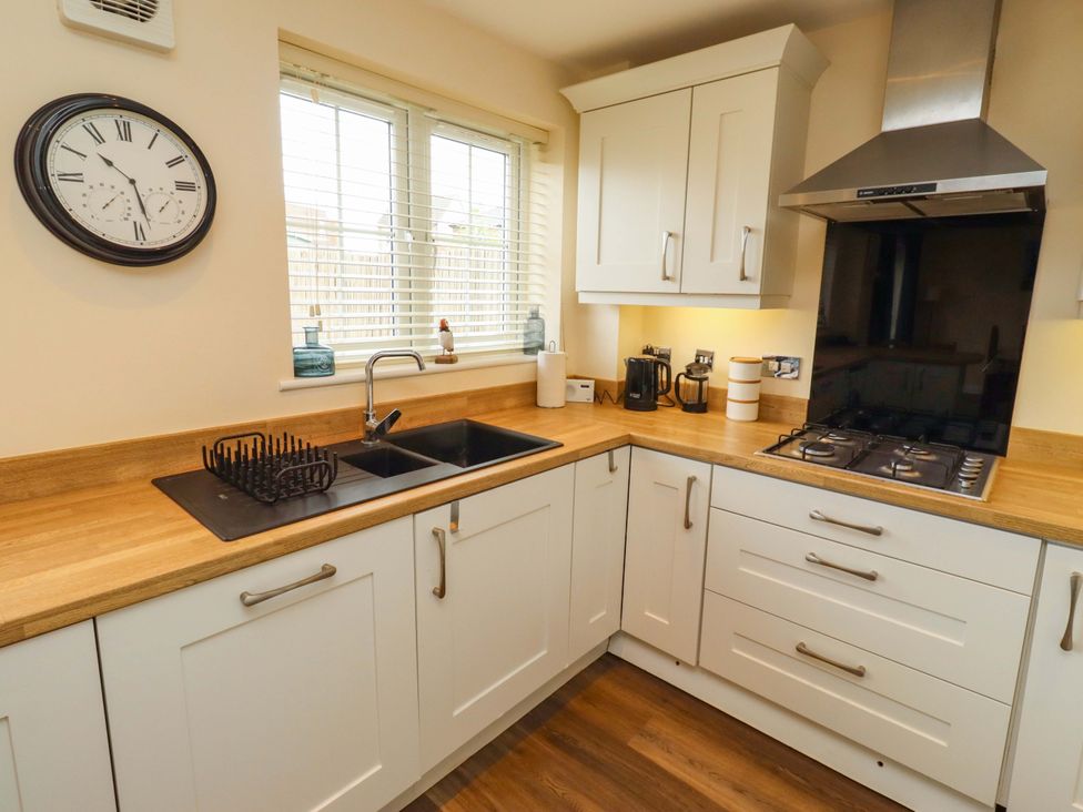 A kitchen with a sink and gas hob at 35 Longbeach Drive