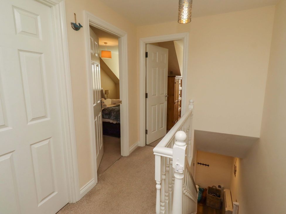 A hallway with doors and staircase at 35 Longbeach Drive
