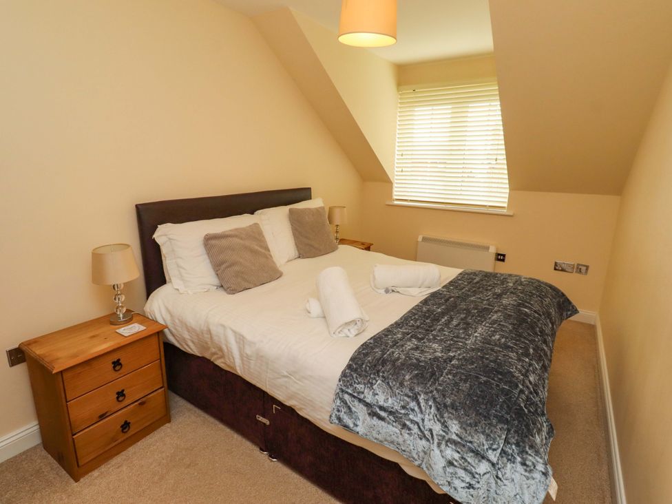 A bedroom with a bed and bedside table at 35 Longbeach Drive