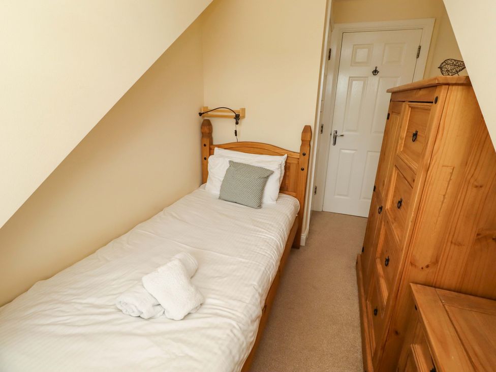 A bedroom with a single bed and wardrobe at 35 Longbeach Drive