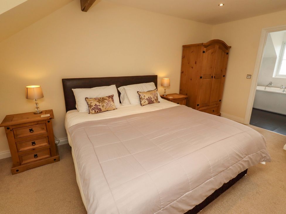 A bedroom with a bed and nightstand at 35 Longbeach Drive 
