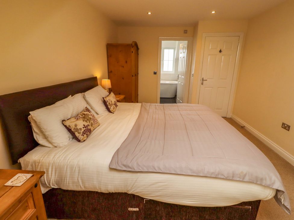 A bedroom with a bed and wardrobe at 35 Longbeach Drive