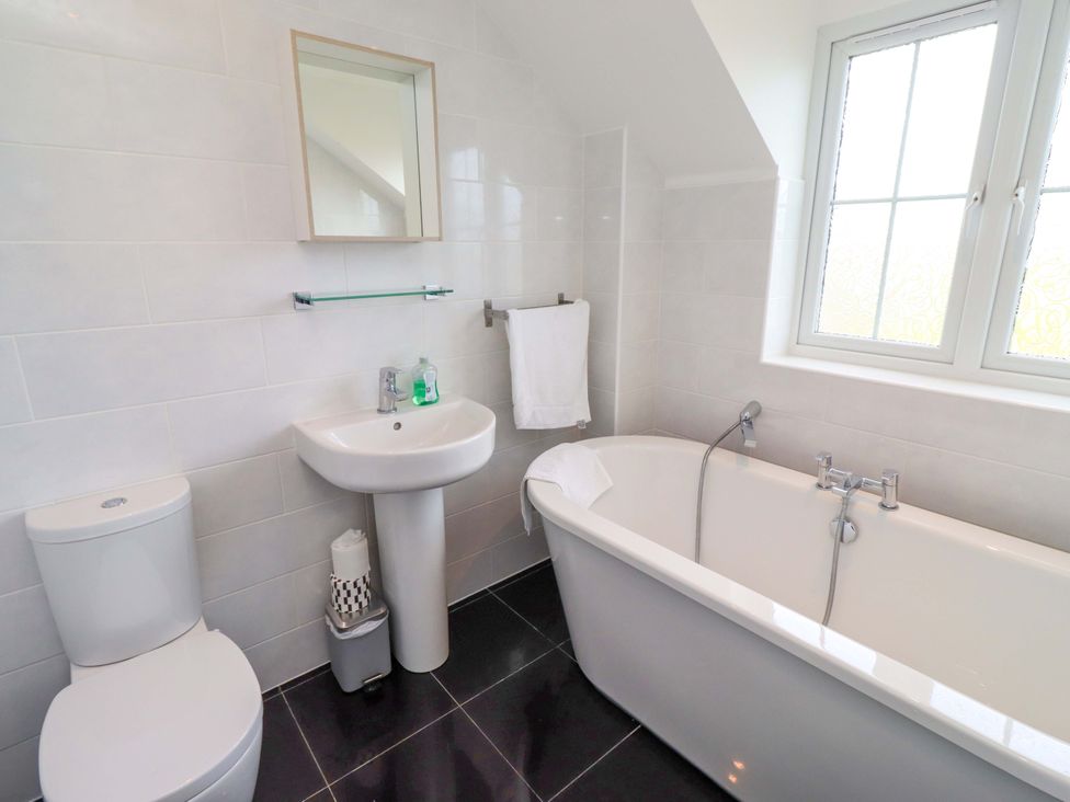 A bathroom with a sink, toilet and bathtub at 35 Longbeach Drive