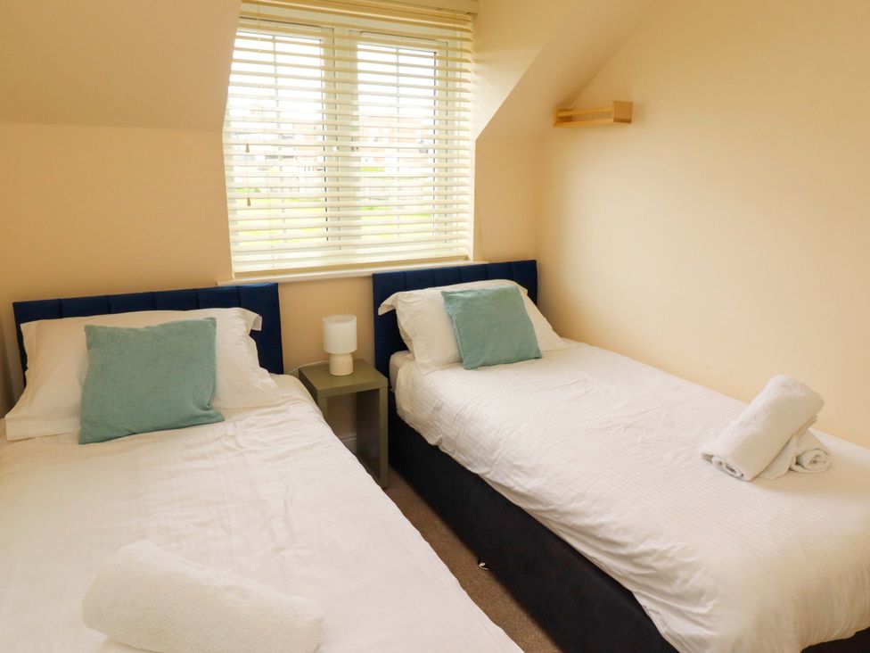 A bedroom with twin beds and a lamp at 35 Longbeach Drive