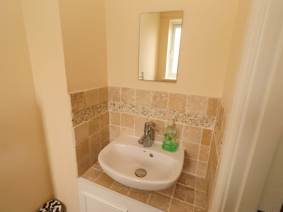 A sink with a mirror and soap dispenser in a bathroom at 35 Longbeach Drive