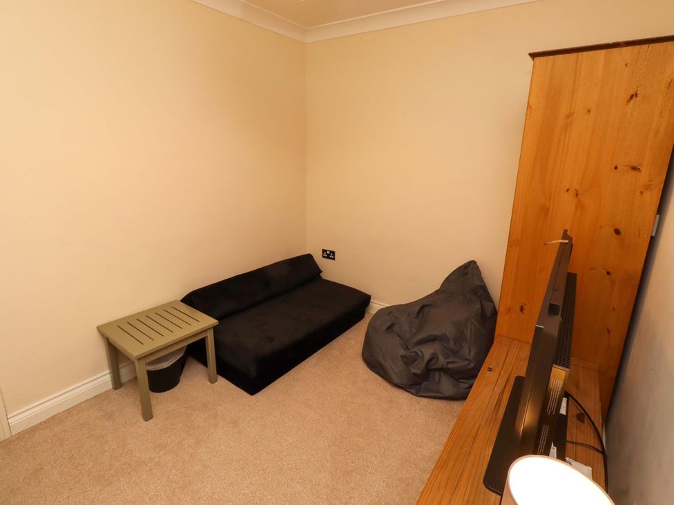 A snug with a sofa and a side table at 35 Longbeach Drive