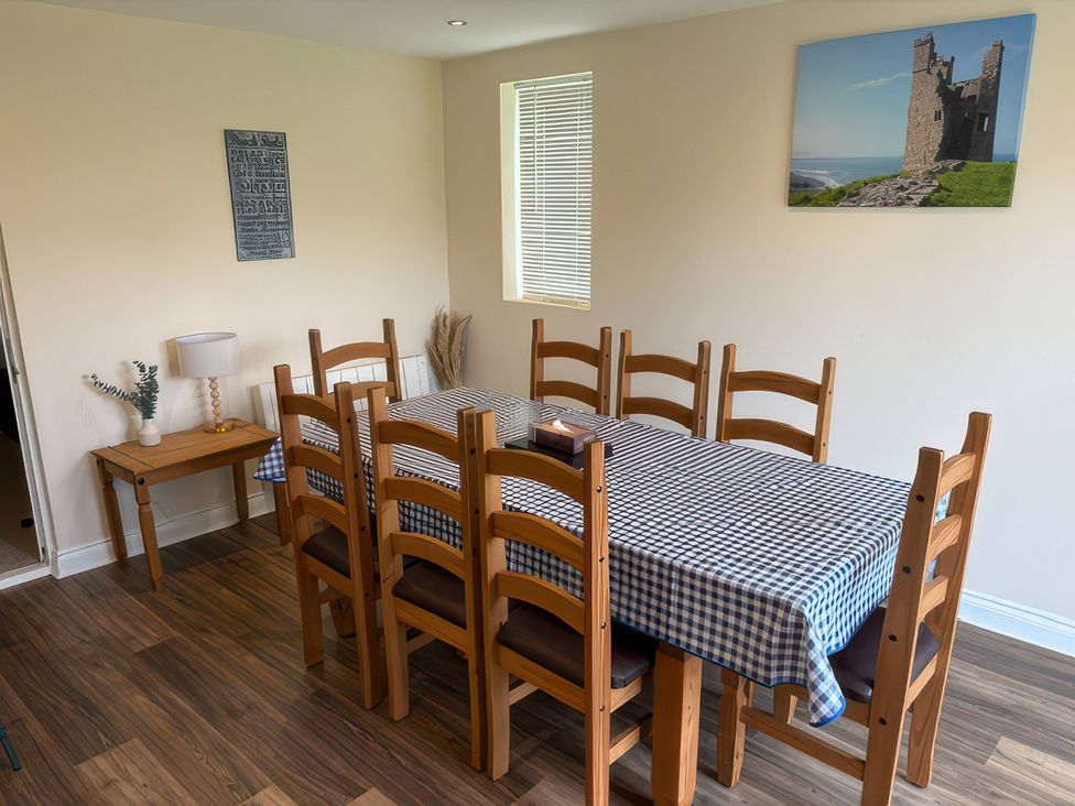 A dining room with a large table and chairs at Nautilus Beadnell