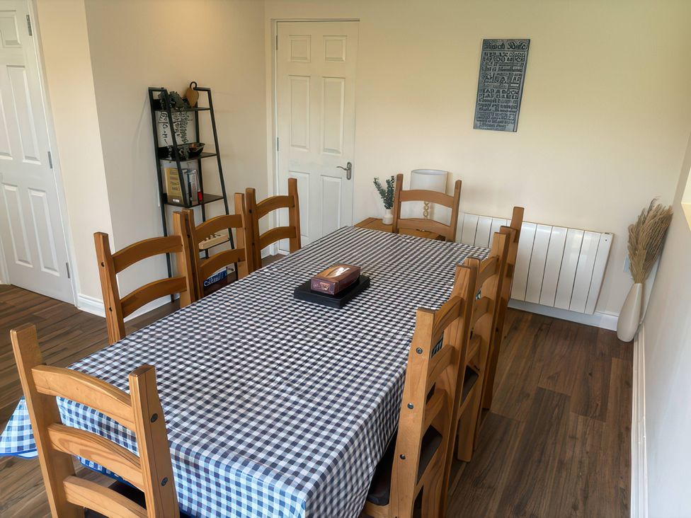 A dining room with a table and chairs at Nautilus Beadnell