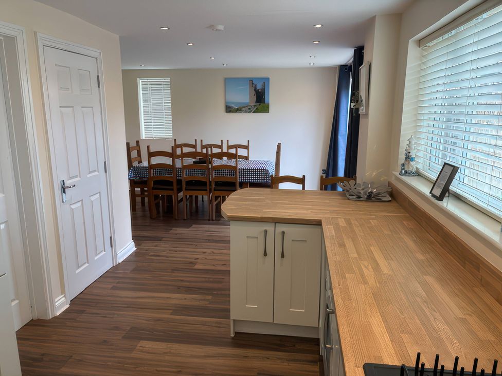 A kitchen with a dining area featuring a table and chairs at Nautilus in Beadnell