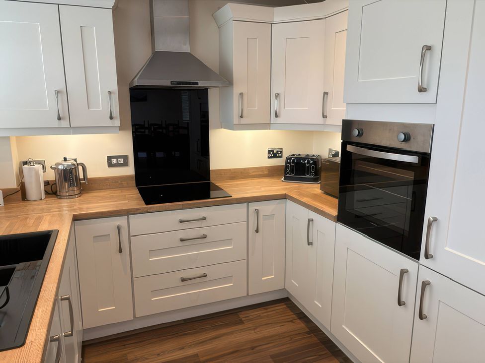 A kitchen with cabinets and appliances at Nautilus Beadnell