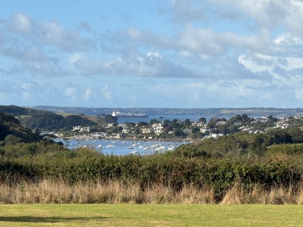 A view of a harbor with boats and houses at The Cowshed in Portscatho