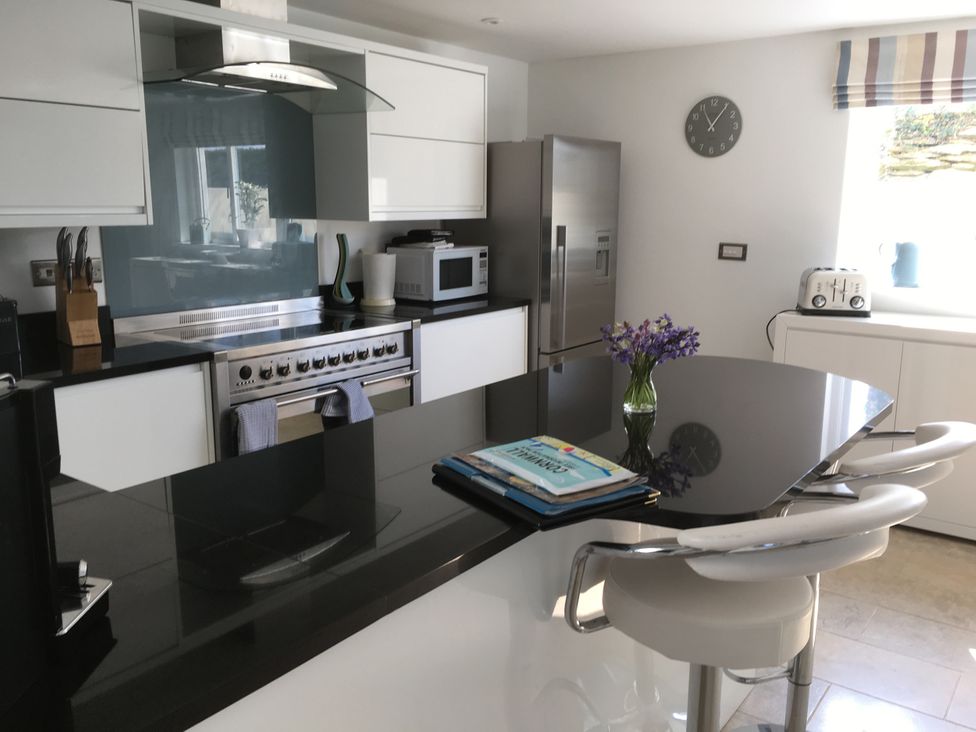 A kitchen with modern fixtures and appliances at The Cowshed in Portscatho