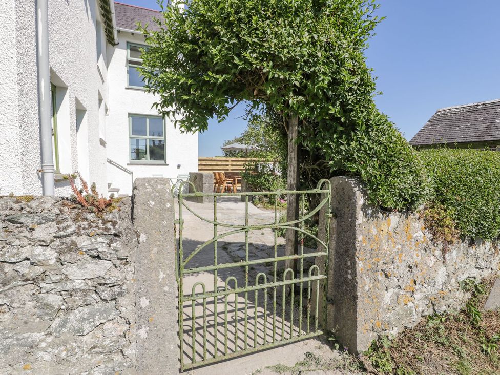 A green gate opening to a pathway at Ty Mawr Farm in Llanfairpwllgwyngyll