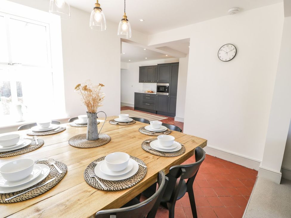 A dining room with a wooden table and chairs at Ty Mawr Farm in Llanfairpwllgwyngyll