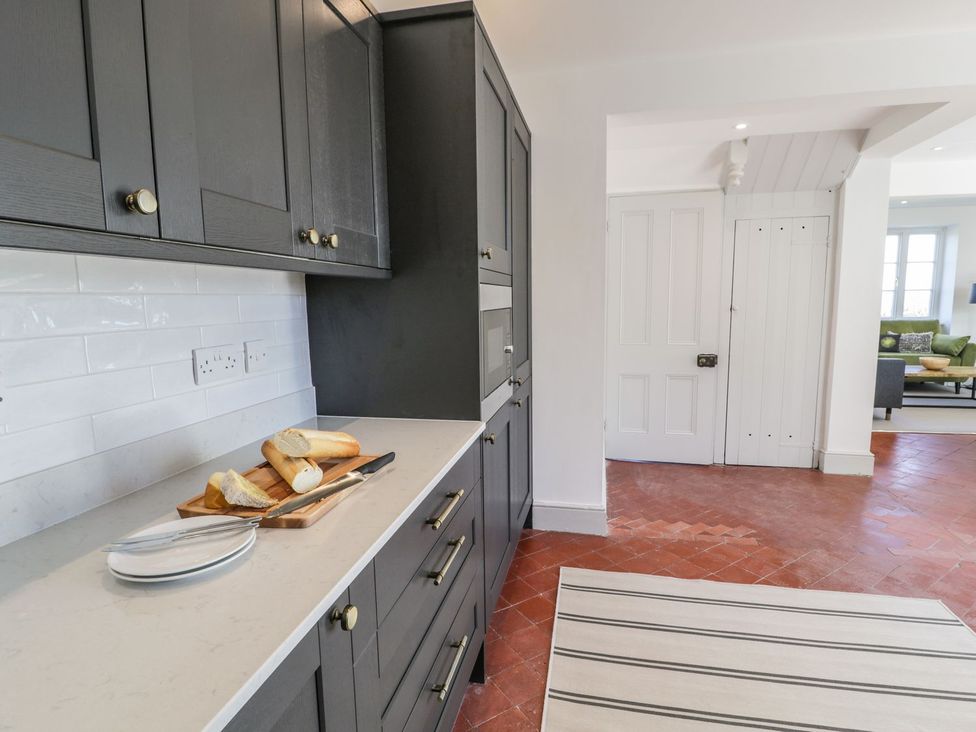 A kitchen with cabinets and bread on a countertop at Ty Mawr Farm in Llanfairpwllgwyngyll