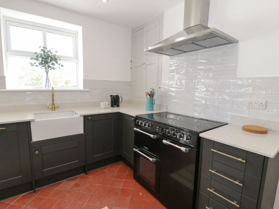 A kitchen with a sink and cooker at Ty Mawr Farm in Llanfairpwllgwyngyll