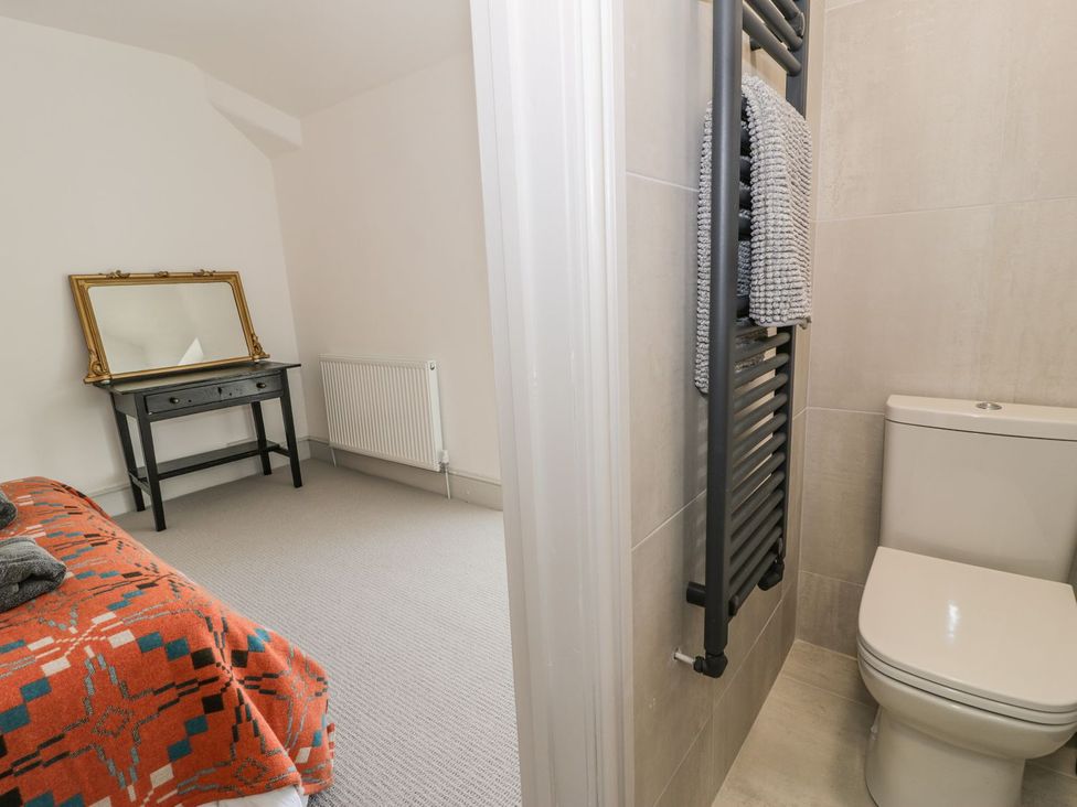 A bedroom with a desk and mirror at Ty Mawr Farm in Llanfairpwllgwyngyll