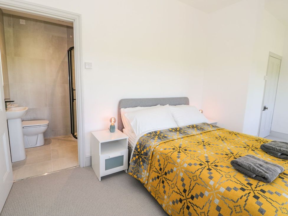 A bedroom with a bed and adjoining bathroom at Ty Mawr Farm in Llanfairpwllgwyngyll