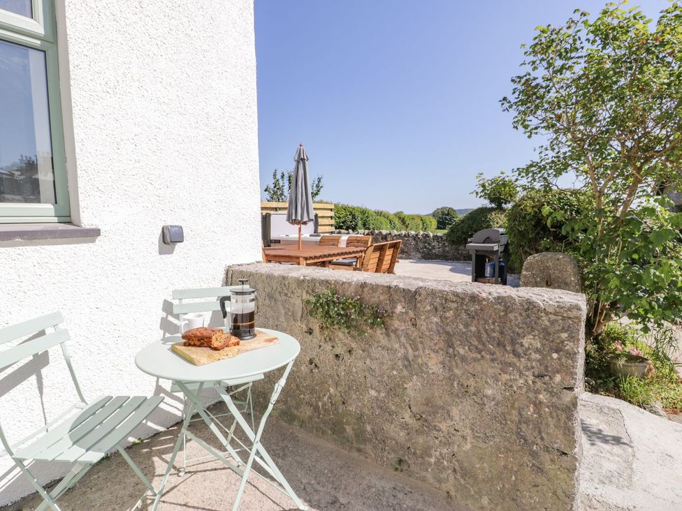 An outdoor seating area with a table and chairs at Ty Mawr Farm in Llanfairpwllgwyngyll