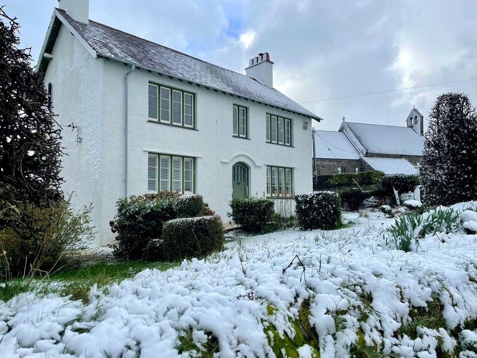 A house with snow in the garden at Ty Mawr Farm Llanfairpwllgwyngyll