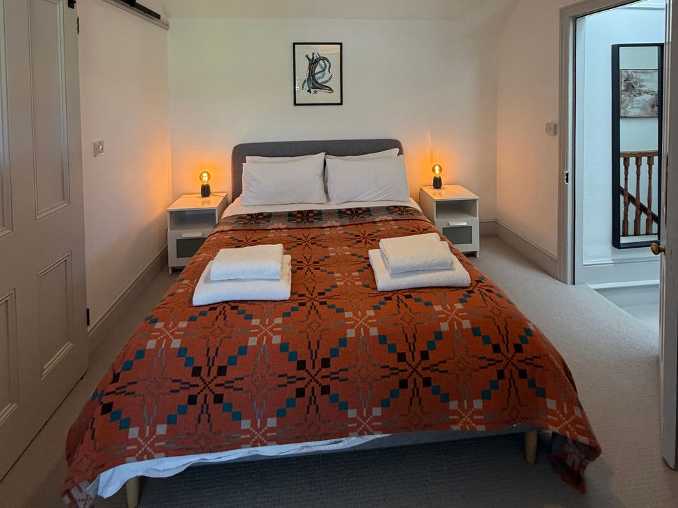 A bedroom with a bed and bedside tables at Ty Mawr Farm Penmynydd near Llanfairpwllgwyngyll