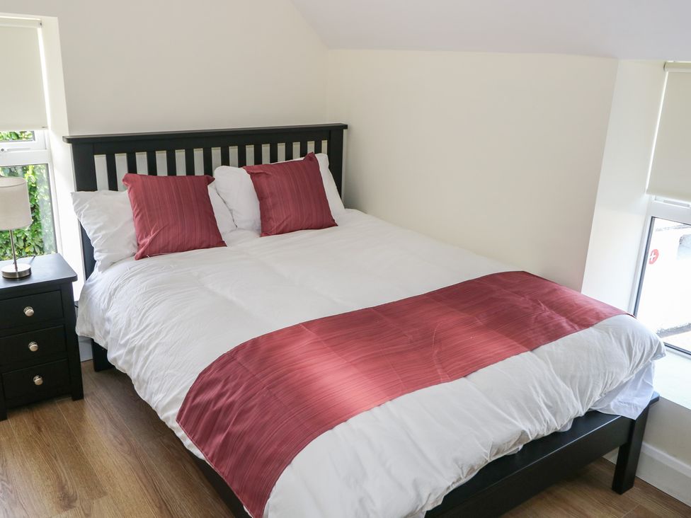 A bedroom with a bed and bedside table at Greenfield House in Aughavas