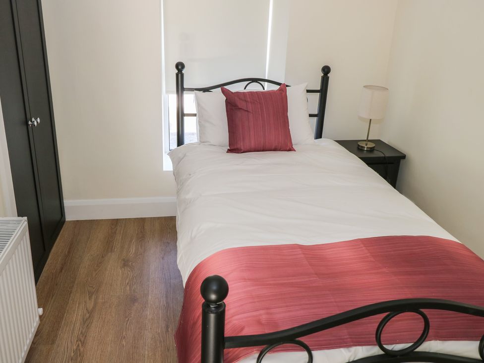 A bedroom with a bed and bedside table at Greenfield House in Aughavas