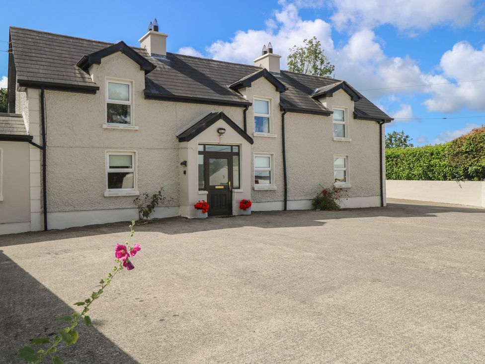 A house with a front door and flower pots at Greenfield House Aughavas, County Leitrim