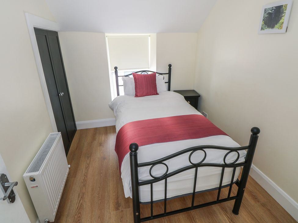 A bedroom with a single bed and nightstand at Greenfield House in Aughavas, County Leitrim