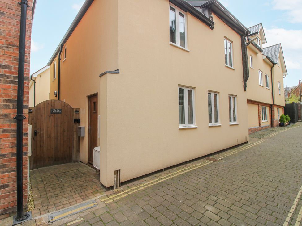 A view of an exterior building with a pathway at The Old China Shop in Ludlow