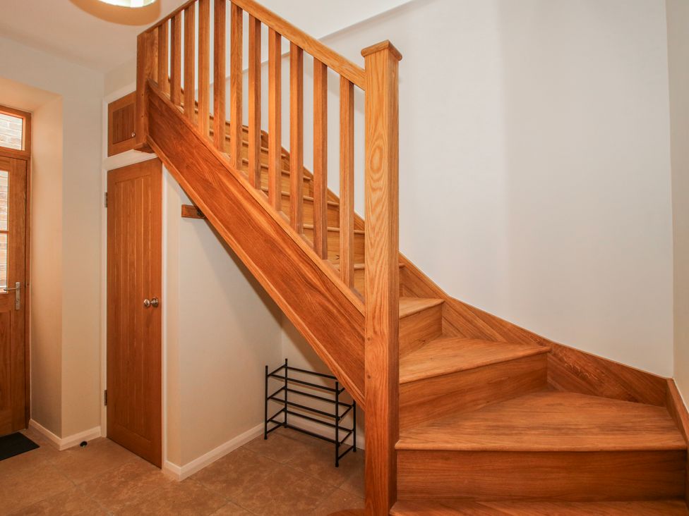 A staircase and door in a hallway at The Old China Shop in Ludlow