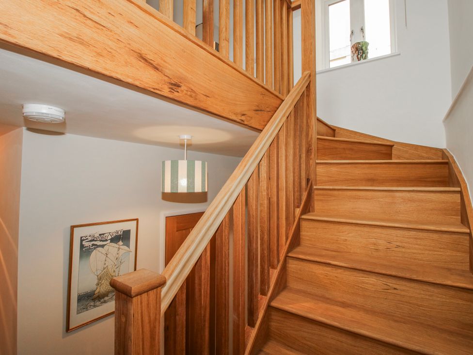 A staircase with wooden steps and a light fixture at The Old China Shop in Ludlow