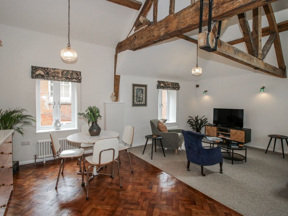 A living room with a dining area and sofa at The Old China Shop in Ludlow