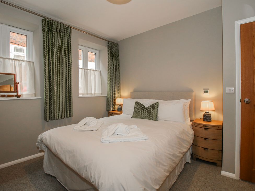 A bedroom with a double bed and nightstand at The Old China Shop in Ludlow