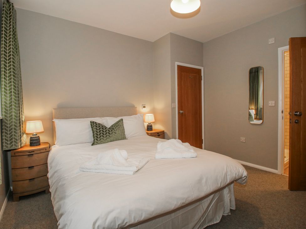 A bedroom with a bed and bedside tables at The Old China Shop in Ludlow