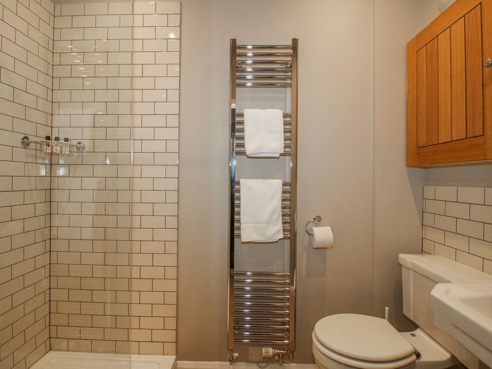 A bathroom with a shower and towel rack at The Old China Shop in Ludlow