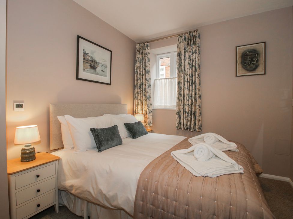 A bedroom with a bed and bedside table at The Old China Shop in Ludlow