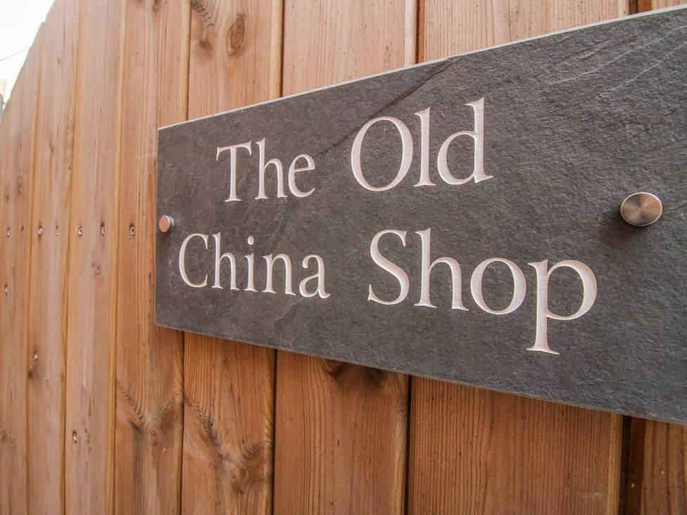 A sign on a wooden fence at The Old China Shop in Ludlow