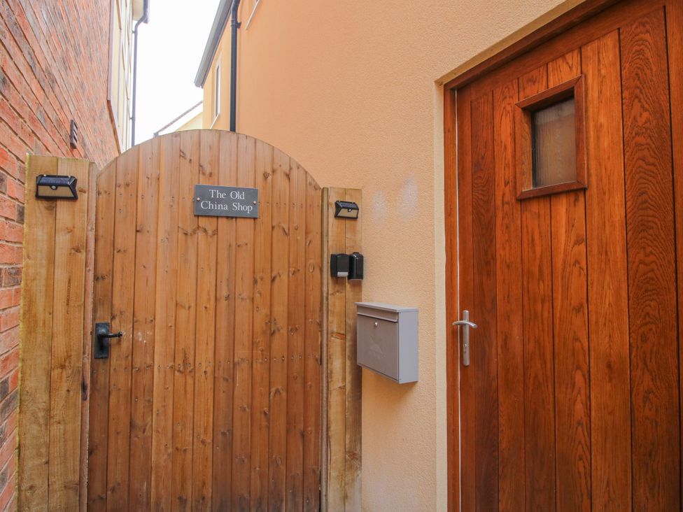 A wooden gate and door at The Old China Shop in Ludlow