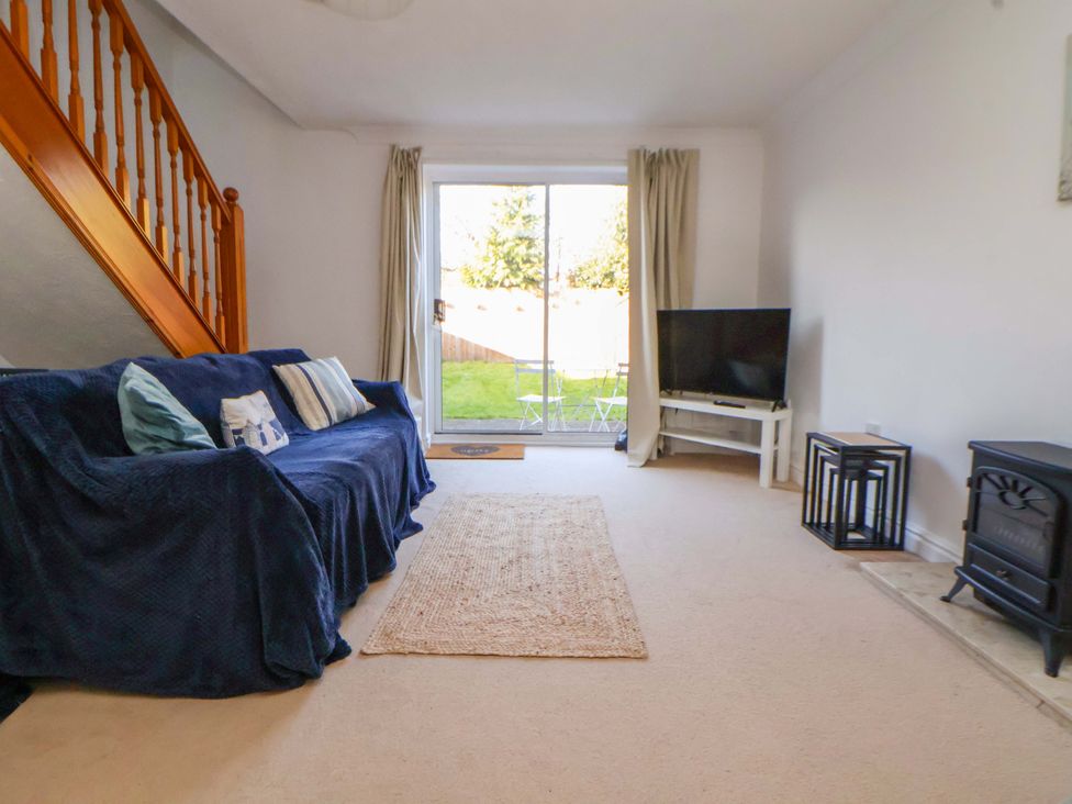 A living room with a sofa and television at 10 Church Walks in Chester