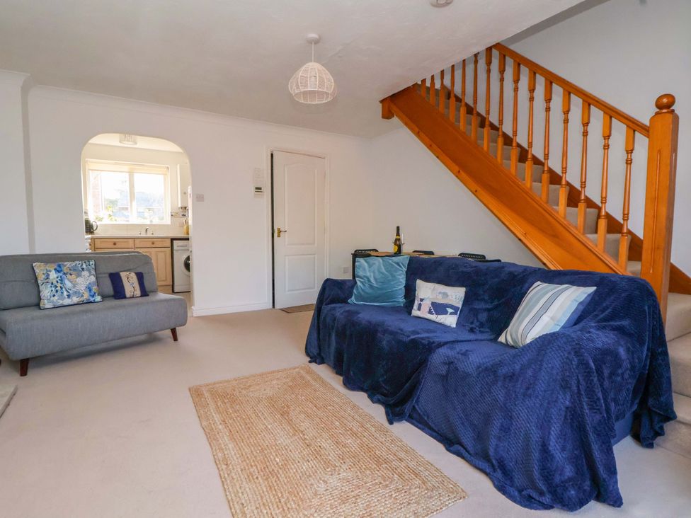A living room with a sofa and staircase at 10 Church Walks Chester