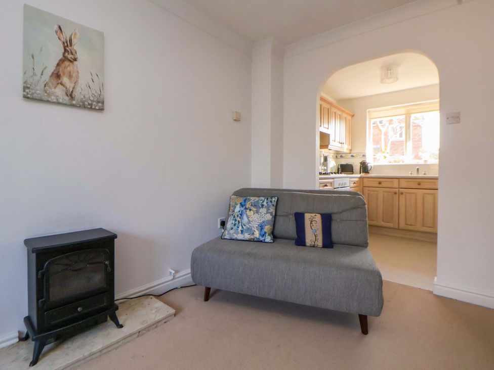 A living room with a sofa and fireplace at 10 Church Walks in Chester